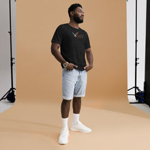 Load image into Gallery viewer, Man wearing the black unisex t-shirt with the Swivel Bottle text and logo on the front in a photoshoot setting.