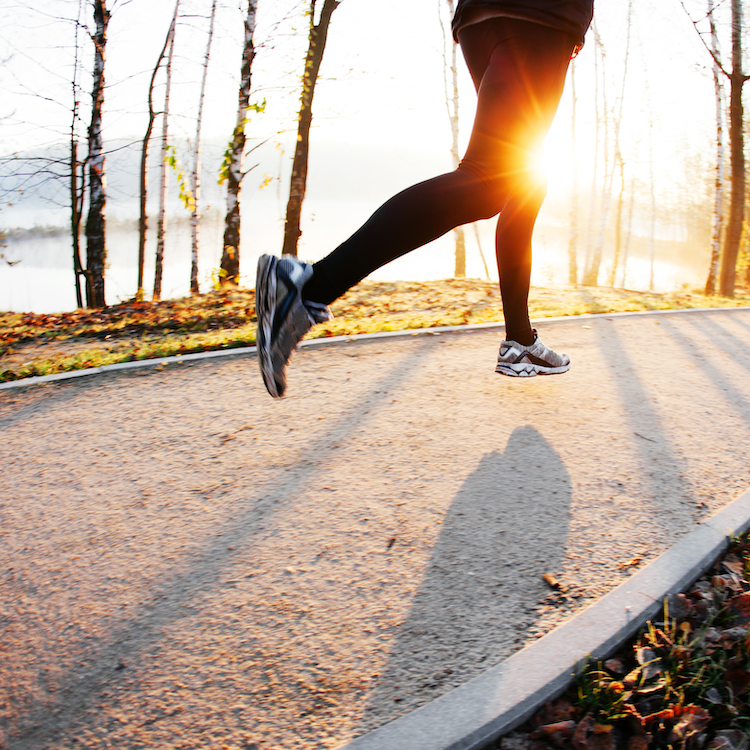 runner on gravel path with sunset 