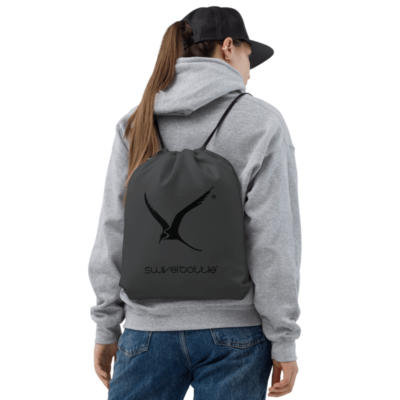 Person wearing a gray hoodie and grey backpack with a logo on a white background.